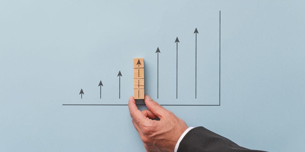 Hand adding growth arrows to chart
