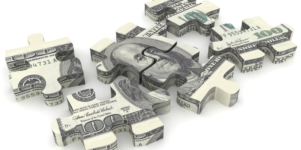 Money puzzle pieces of a hundred dollar bill