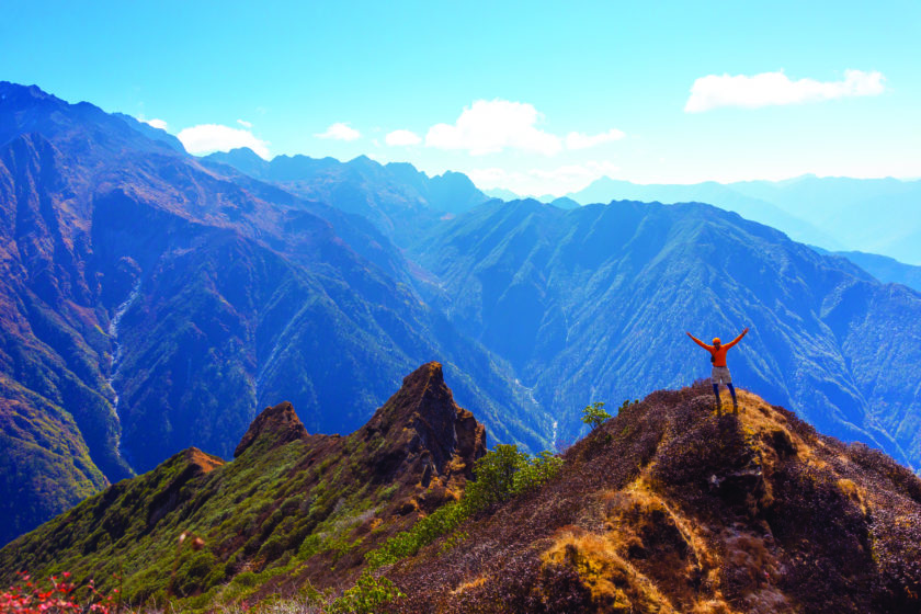 A man proud of his mountain climbing achievement