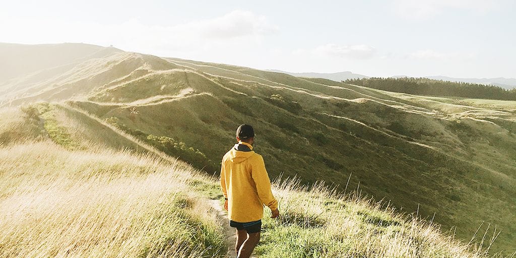 A man on a mountain searching for something.